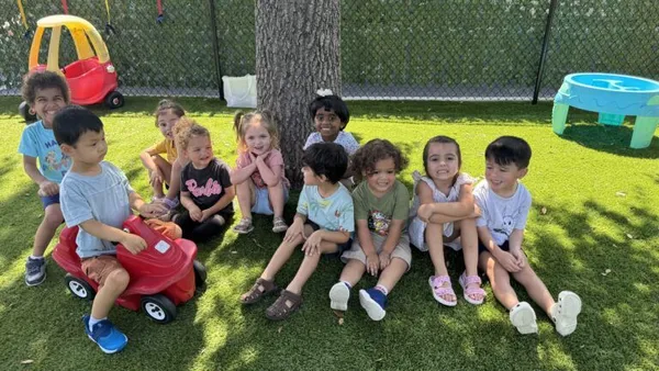 Happy children playing outdoors on green grass