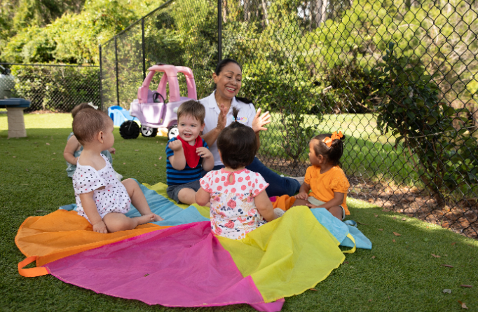 Teacher leading outdoor activities with toddlers at MiniArt