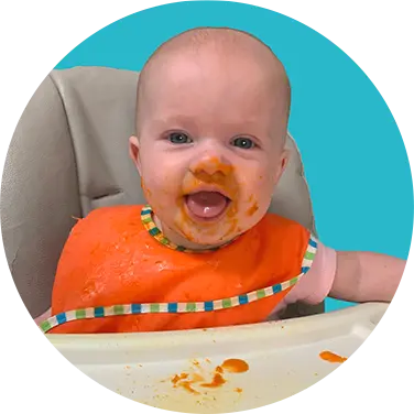 happy baby eating at preschool