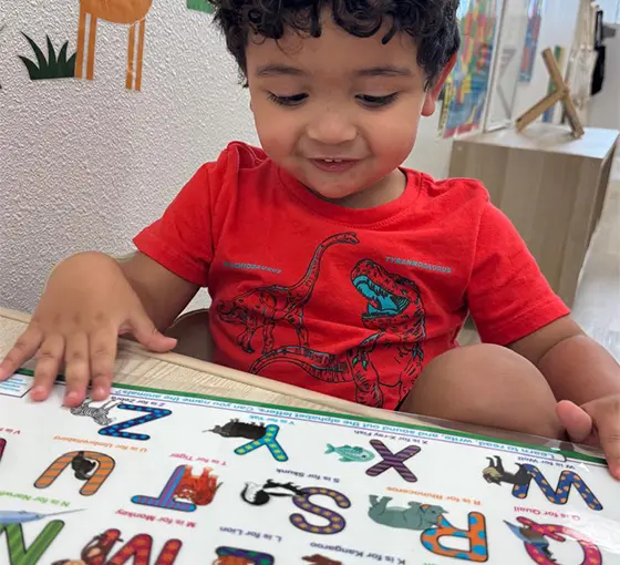 little pre school boy kid reading and learning