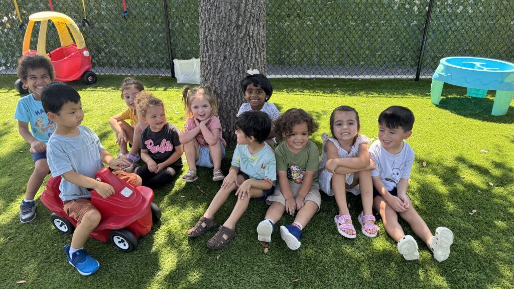 Happy children playing outdoors on green grass